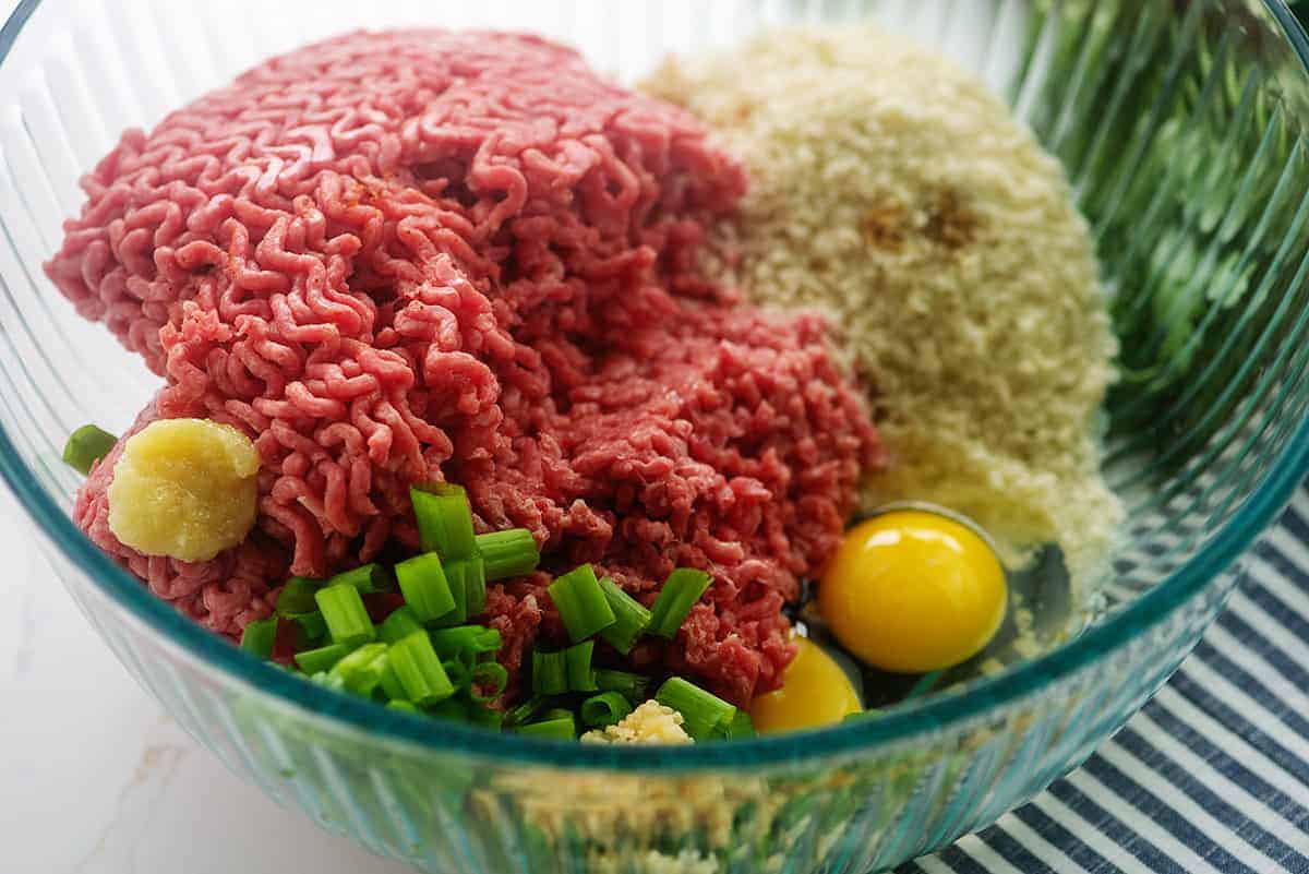 ingredients for teriyaki meatballs in glass mixing bowl.