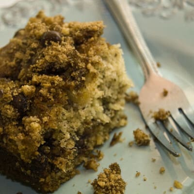 A half-eaten piece of coffee cake with a fork.