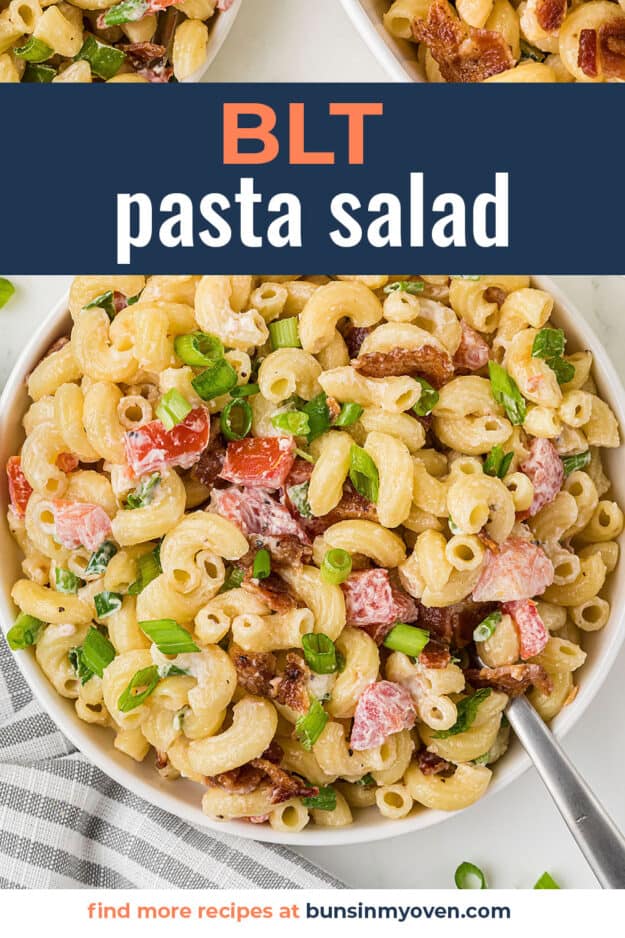 Bacon pasta salad in white bowl with spoon.