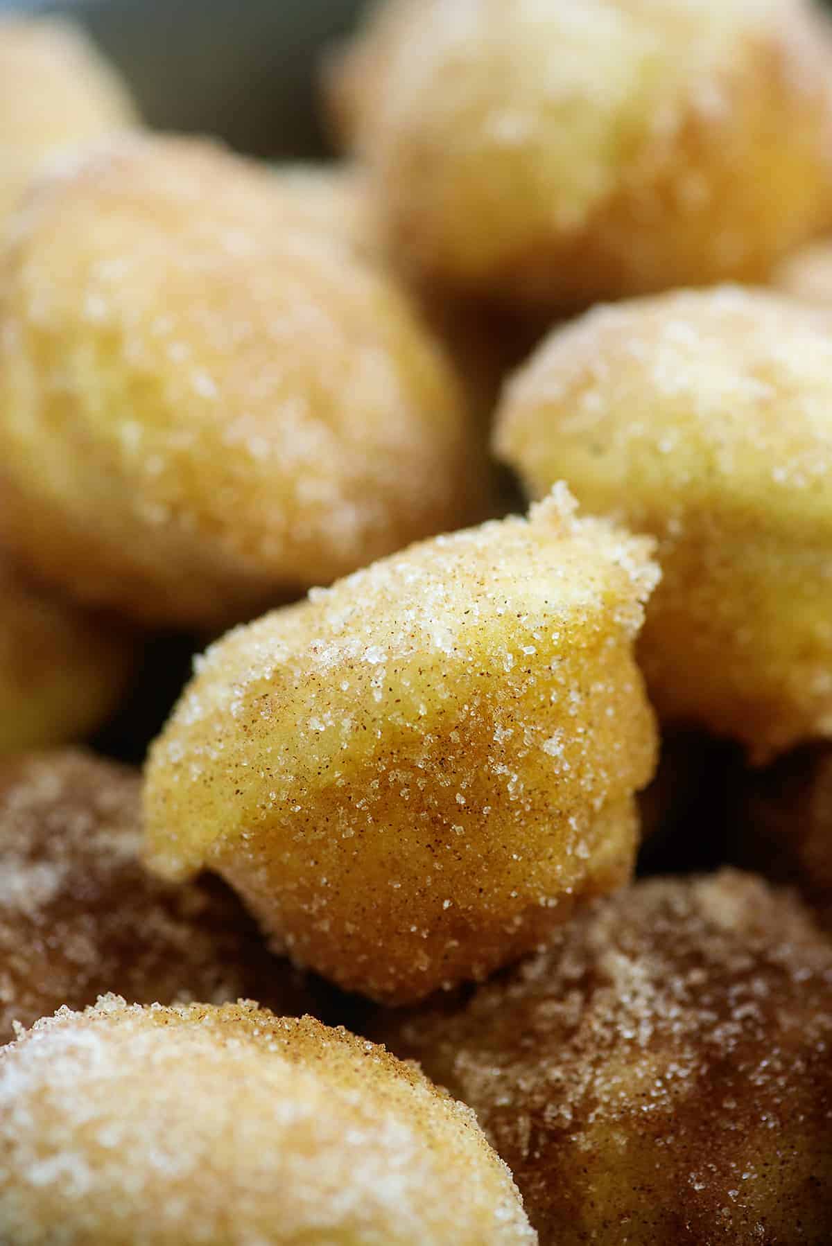 sugar-donut-muffins-on-plate pile of cinnamon sugar donut muffins.