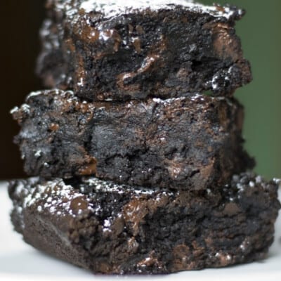 Three chocolate brownies stacked up.