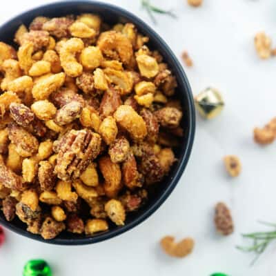 overhead view of cinnamon sugar roasted nuts in black bowl.