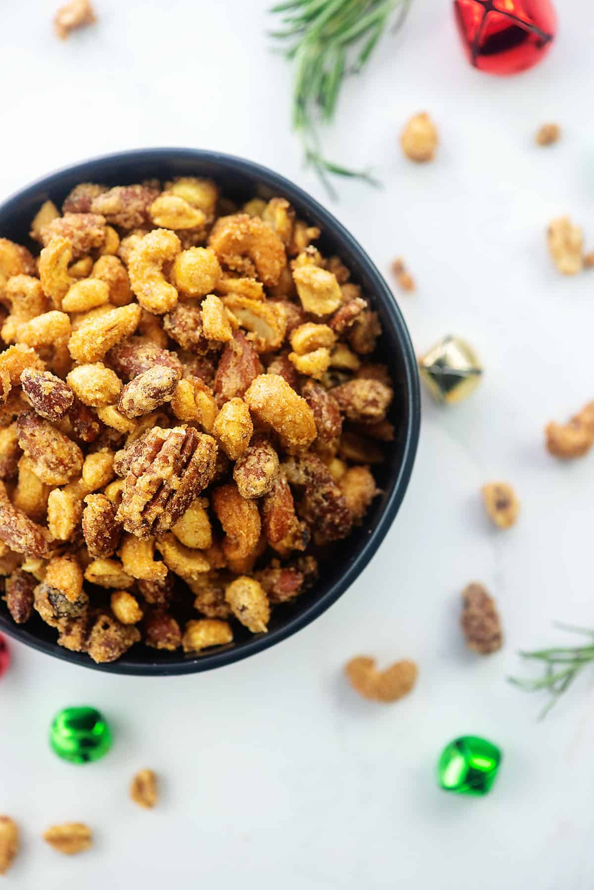 overhead view of cinnamon sugar roasted nuts in black bowl.