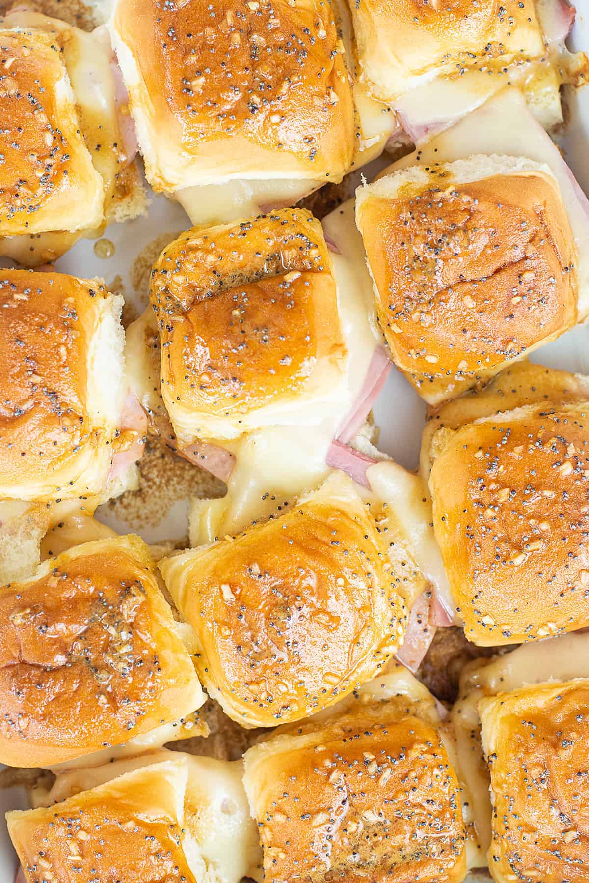 Hawaiian roll ham and cheese sliders in baking dish.