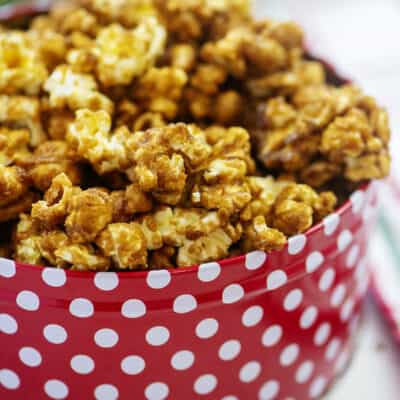 Homemade caramel corn in Christmas tin.