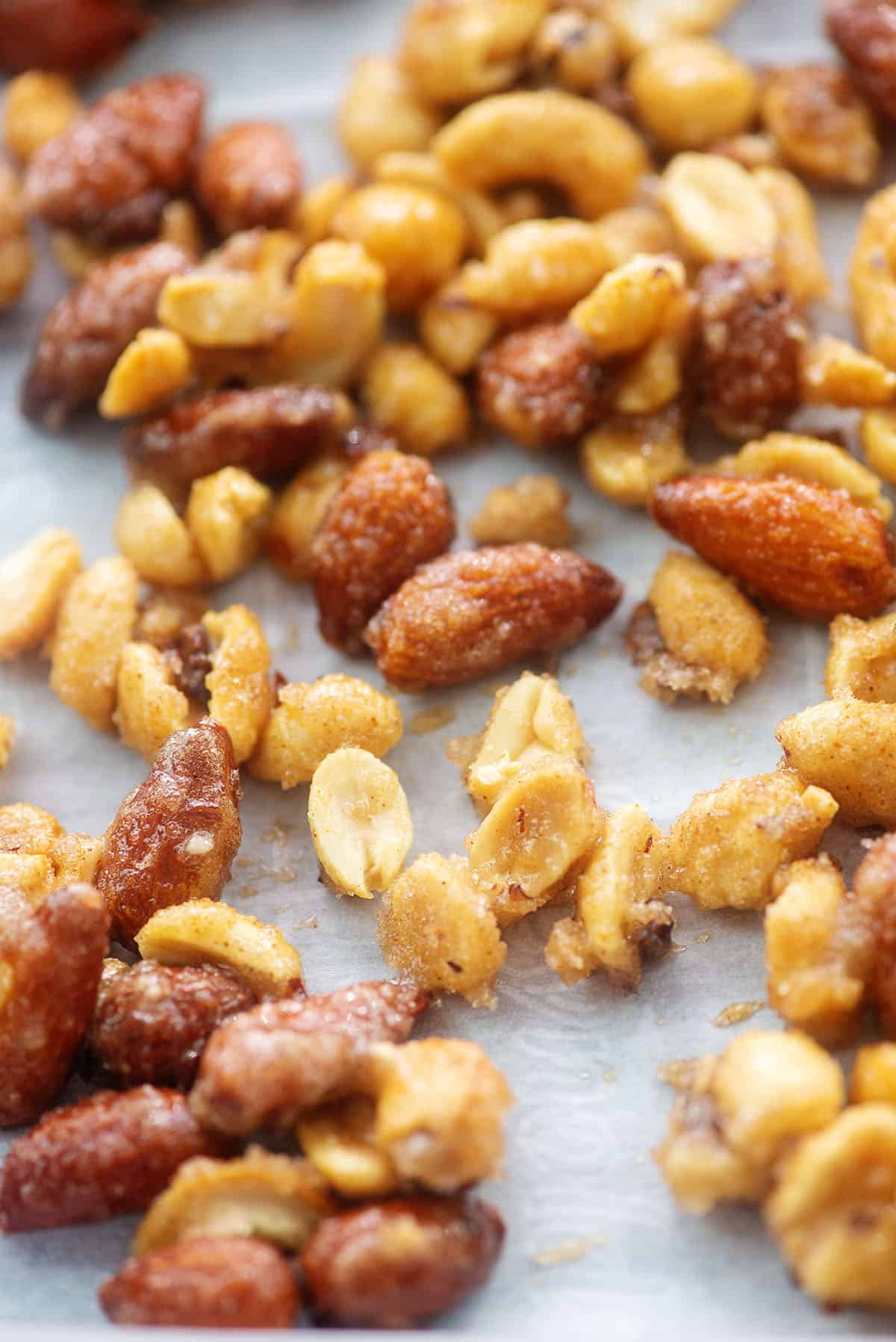 nuts coated in cinnamon and sugar on baking sheet.