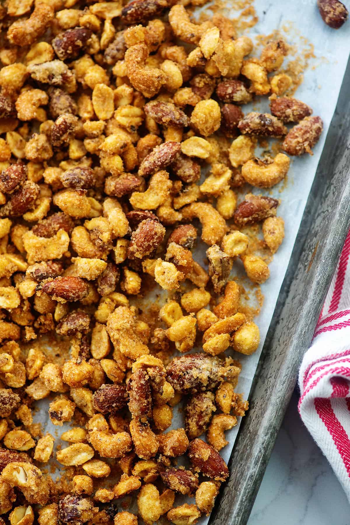 overhead view of candied nuts on baking sheet.