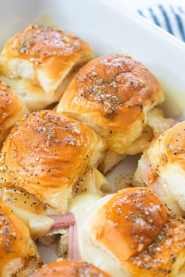 Hawaiian ham and cheese sliders in white baking dish.