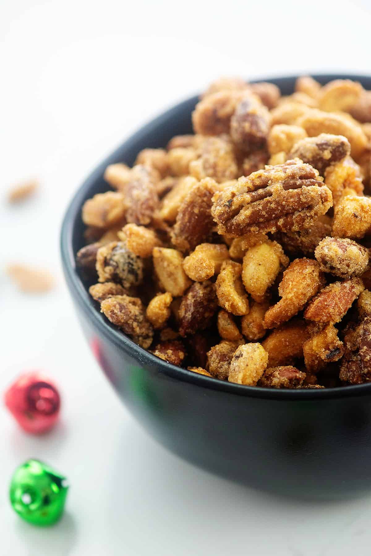 black bowl full of candied nuts.