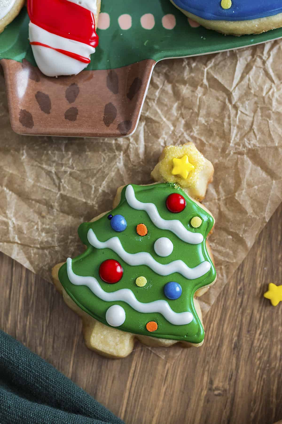 Butter cookie cut out and decorated as a Christmas tree.