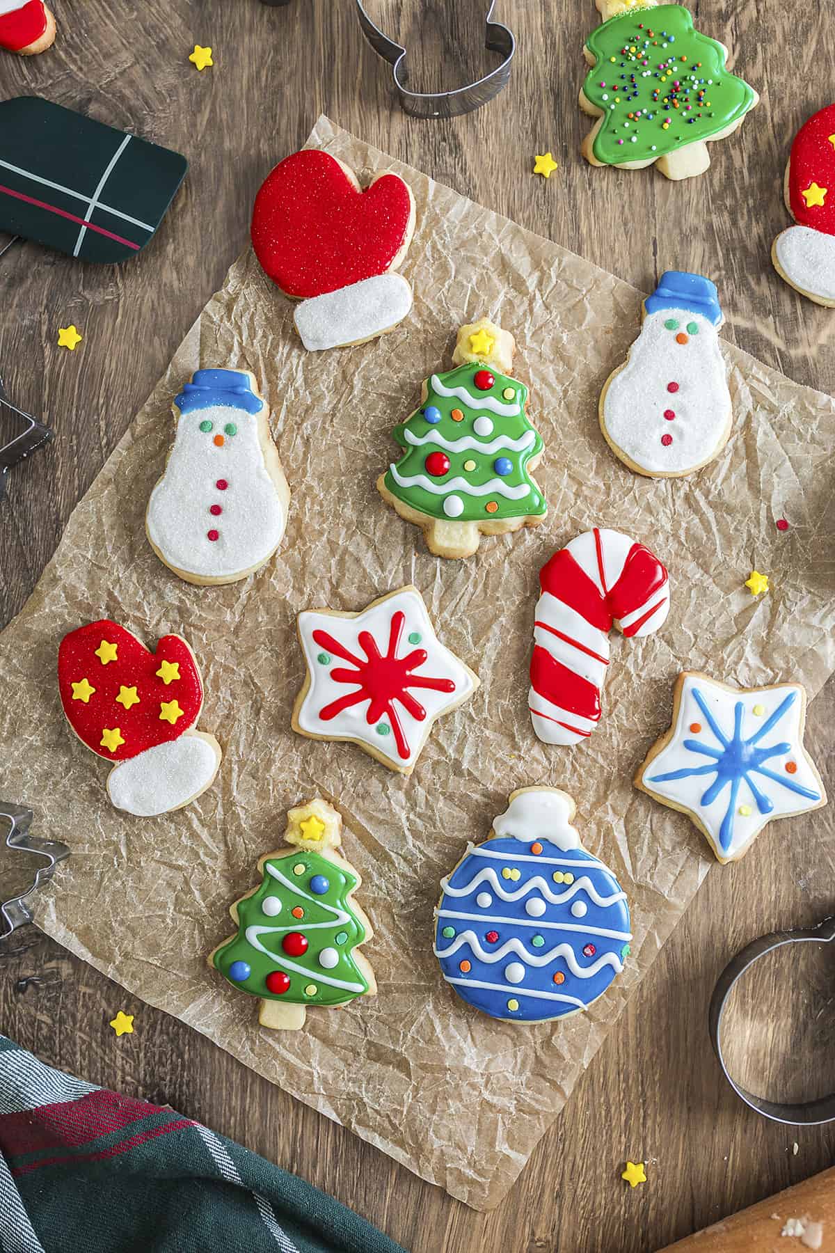 Decorated cut out cookies on parchment paper.