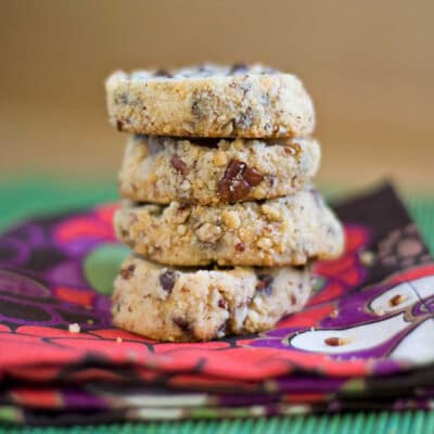 The stacked up cheesecake cookies on a colorful napkin