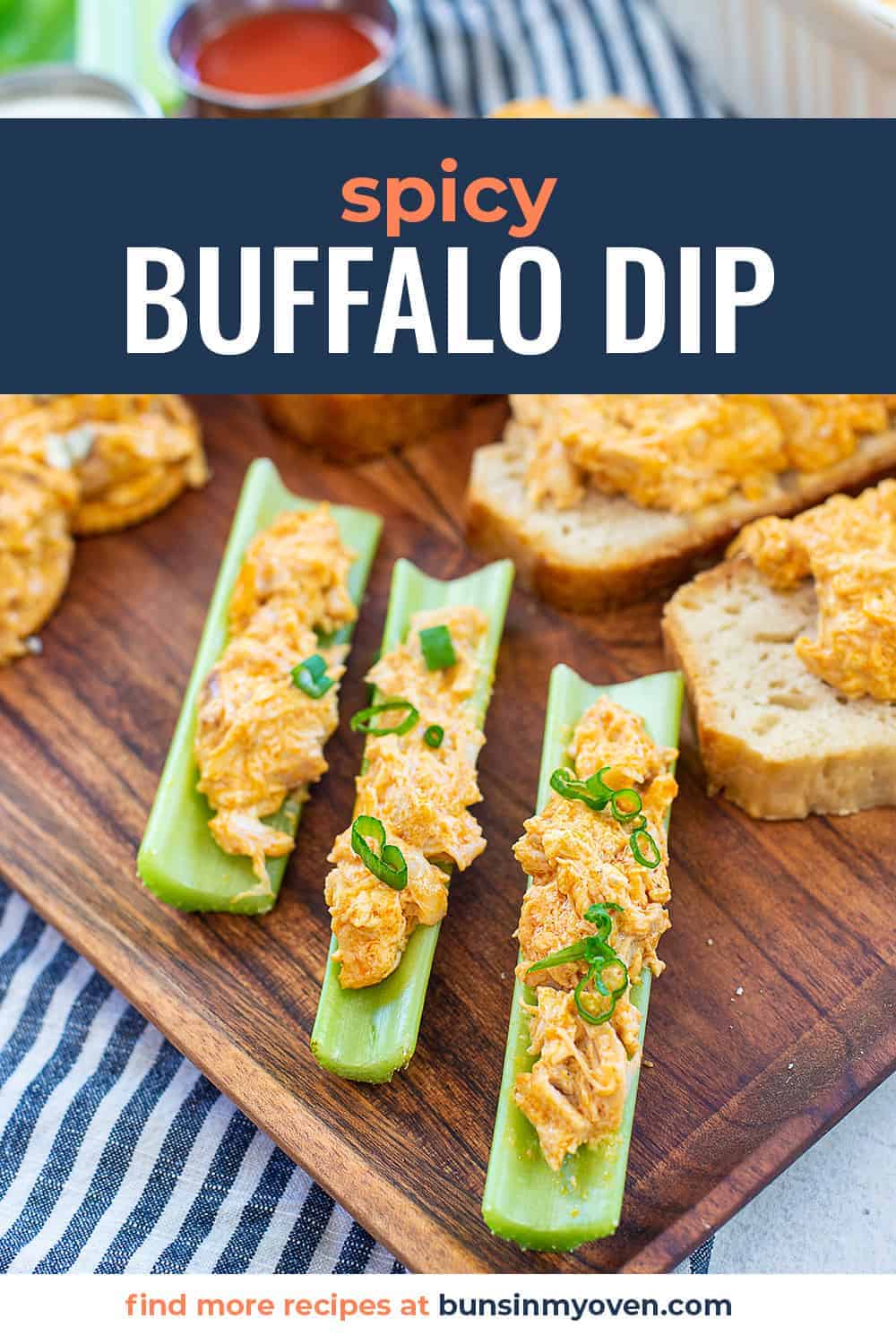 celery filled with buffalo chicken dip on wooden board.