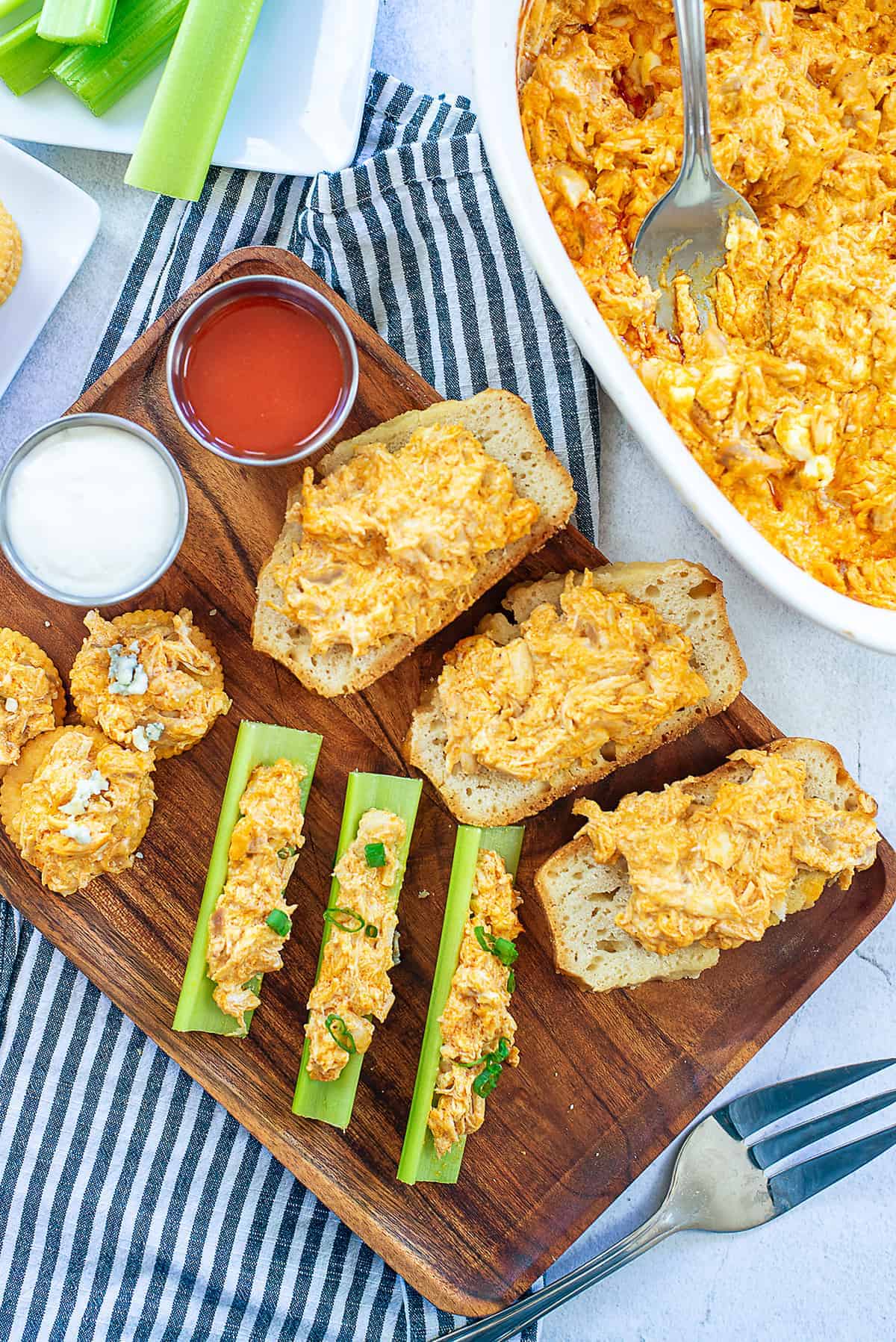 overhead view of buffalo chicken dip on celery and bread.