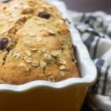 Blueberry bread in yellow loaf pan.