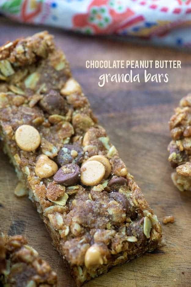 Granola bar with chocolate chips and peanut butter chips on a wooden table.
