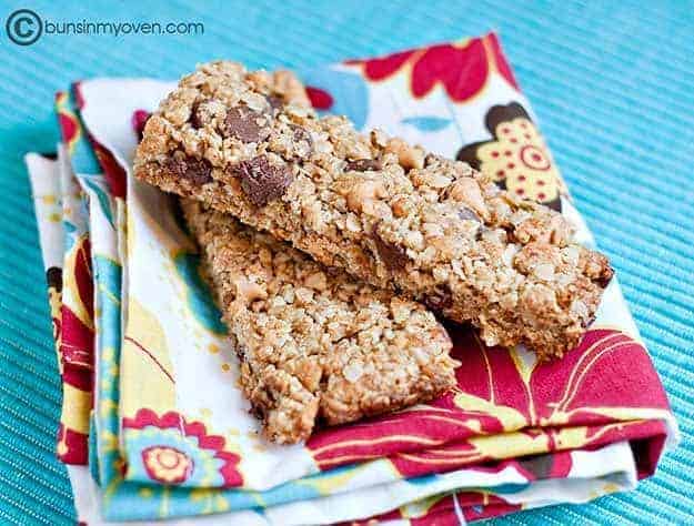 Stacked chocolate peanut butter granola bars on a folded cloth napkin.