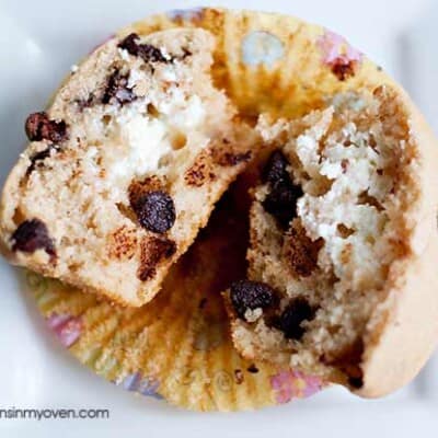 An overhead view of a chocolate chip muffin split open.