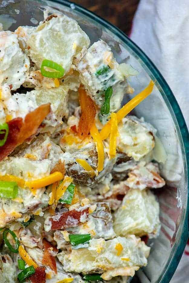 A clear glass bowl with salad in it.