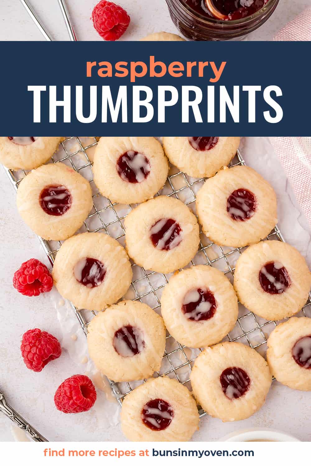 Raspberry thumbprint cookies on wire rack.