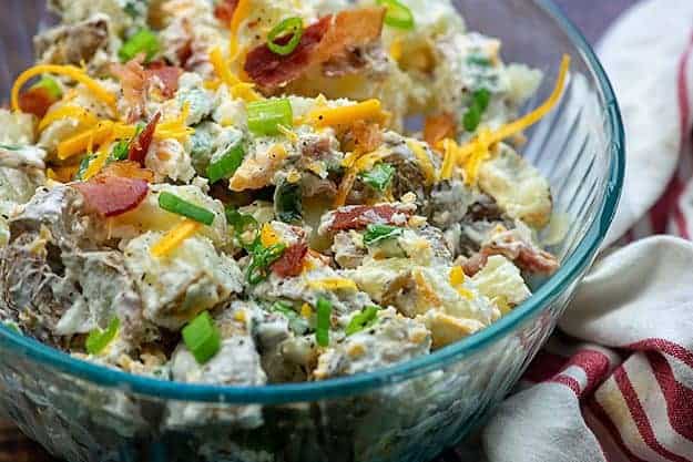 baked potato salad in glass bowl.