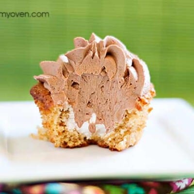 A close up of a smores cupcake with a bite taken out of it.