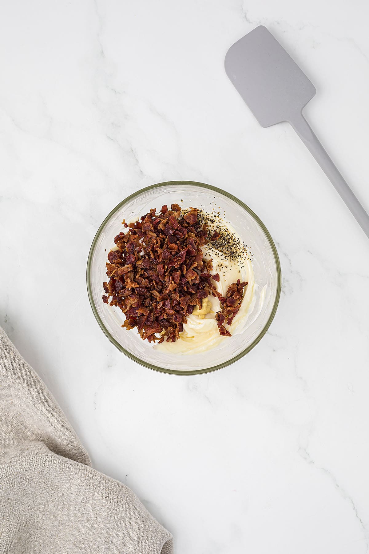 Ingredients for bacon butter in small glass mixing bowl.