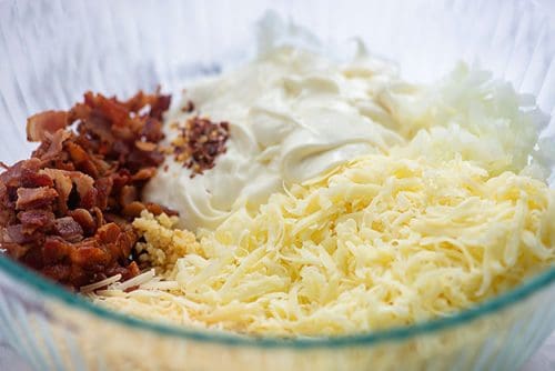 bacon cheese dip ingredients in a glass bowl.