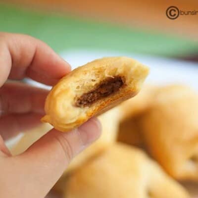 A chocolate-filled crescent roll being held up to the camera