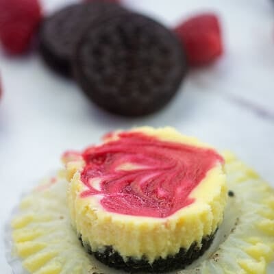 cheesecake on muffin liner with oreos and raspberries