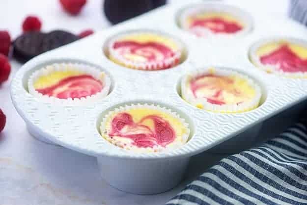 mini cheesecakes in white muffin pan