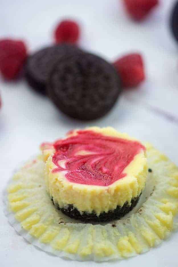 cheesecake on muffin liner with oreos and raspberries