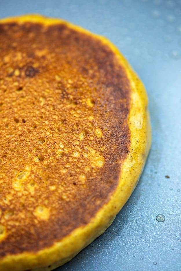 close up of a pancake cooking on a griddle