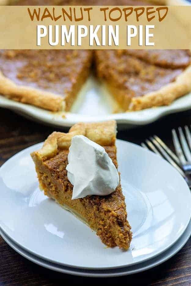 Pumpkin pie on a small round plate topped with whipped cream.