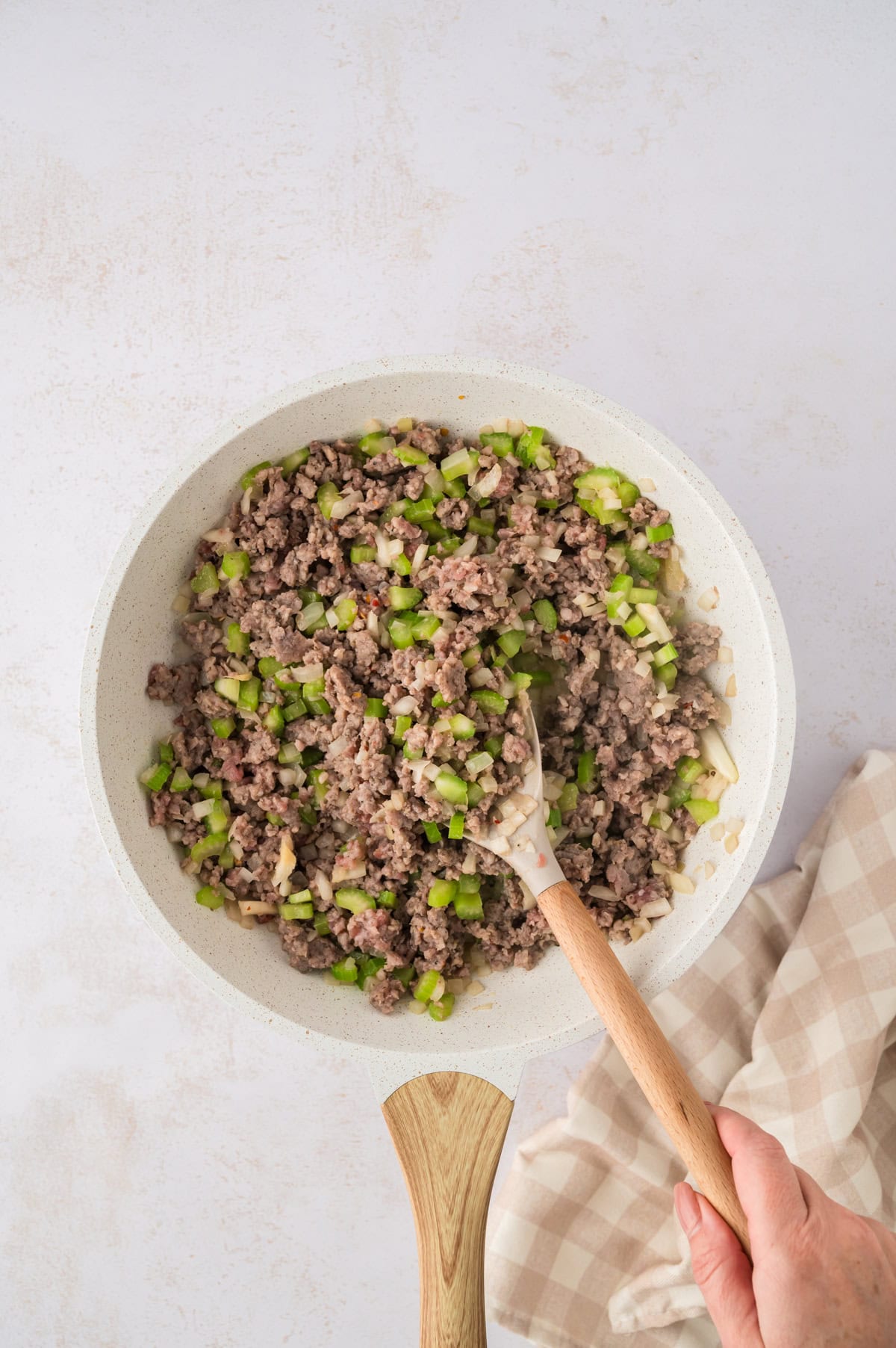 Sausage being browned in skillet.