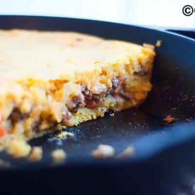 A closeup of Mexican corn bread in a cast iron skillet