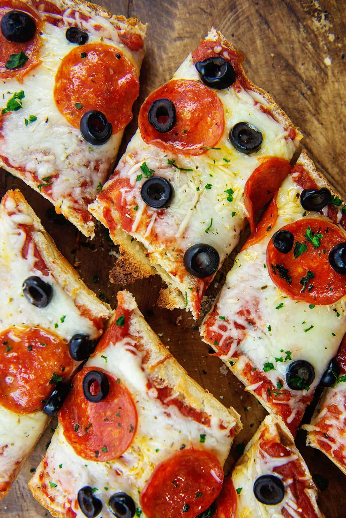 sliced pizza bread on wooden board.