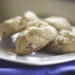 A pile of chocolate chip cookies on a white plate