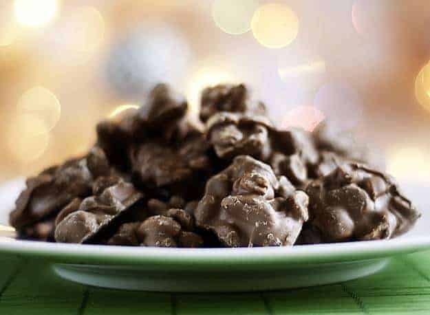 A stack of chocolate covered peanuts on a plate.