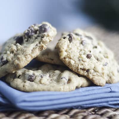 A stack of chocolate chip cookies on a folded cloth napkin