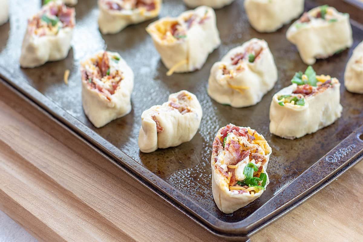 cheddar bacon pinwheels on baking sheet.