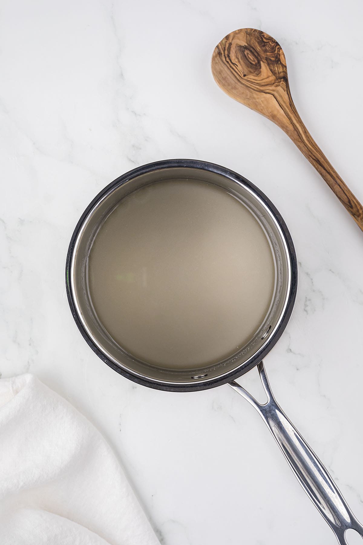 Water and sugar in saucepan to make caramel sauce.