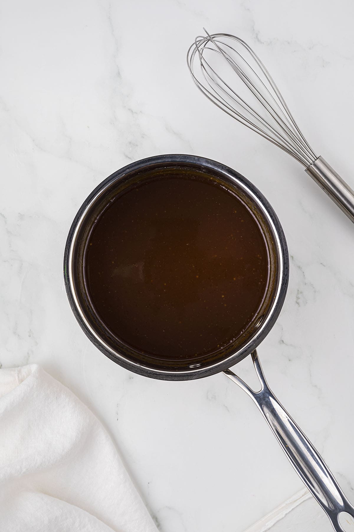Homemade caramel sauce in saucepan.