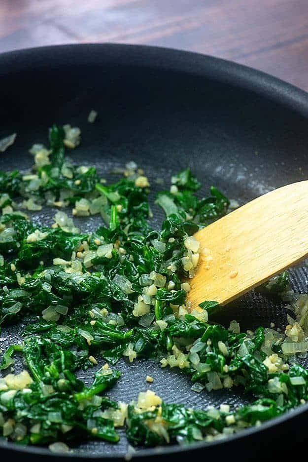 cooked spinach in pan for spinach manicotti