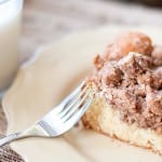 A piece of coffee cake on a plate with a fork