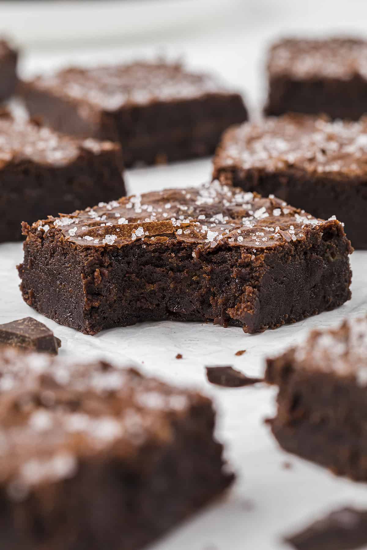 Baked salted caramel brownie with a bite taken out of it.