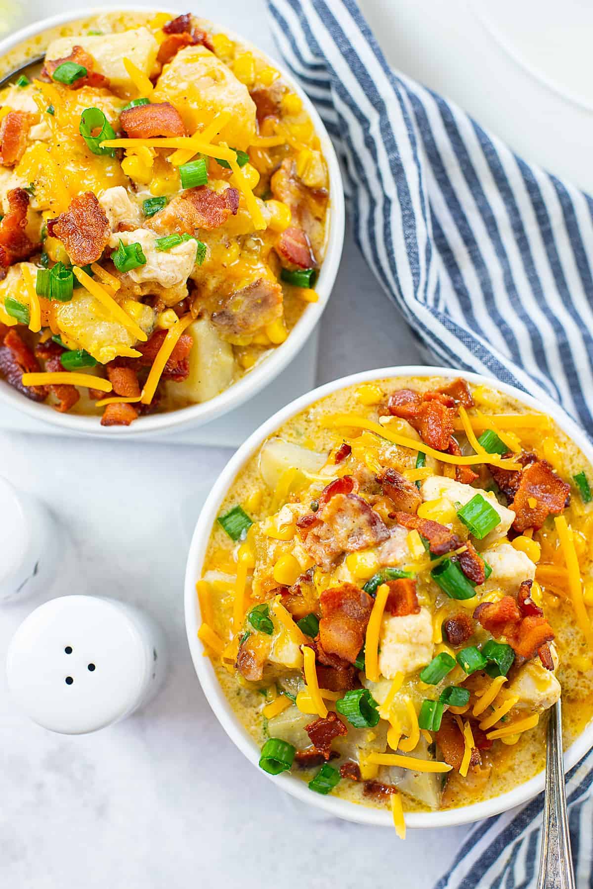 chicken and corn chowder in white bowls.