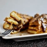 A fork holding a bite of chocolate peanut butter French toast