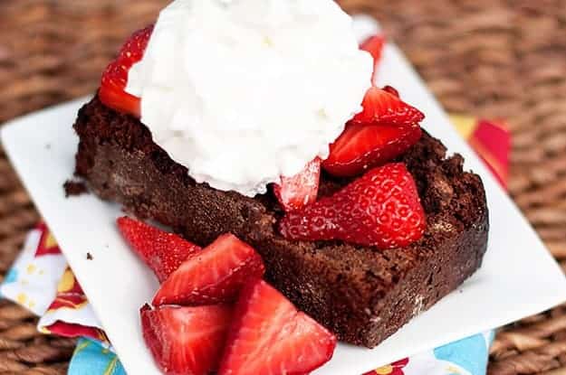 A closeup of chocolate strawberry shortcake topped with whipped cream