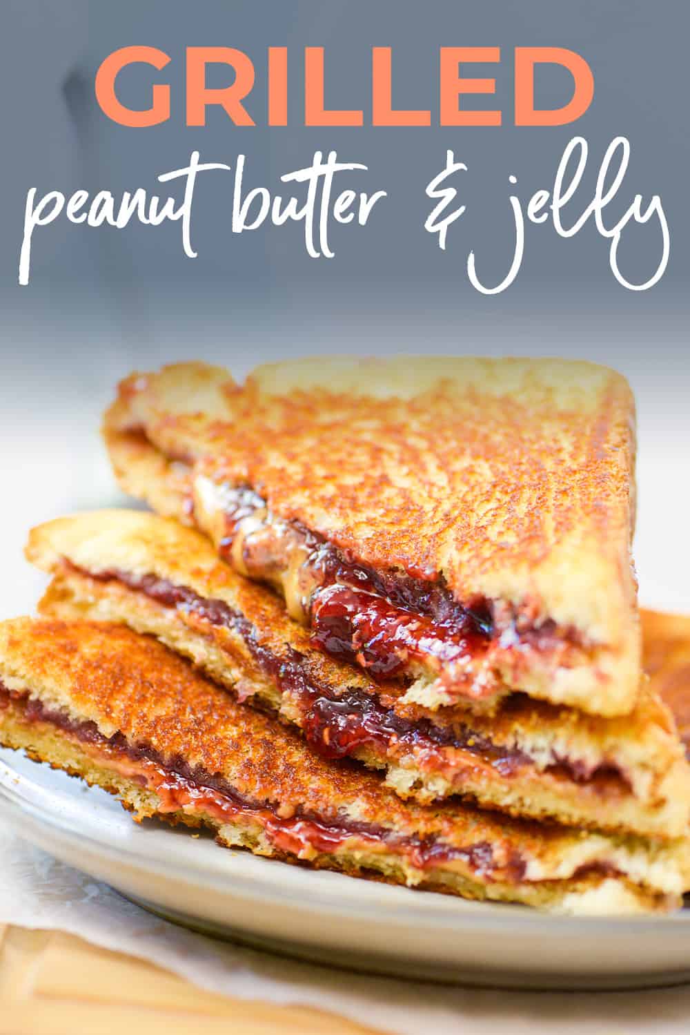 Stack of peanut butter and jelly sandwiches on plate.